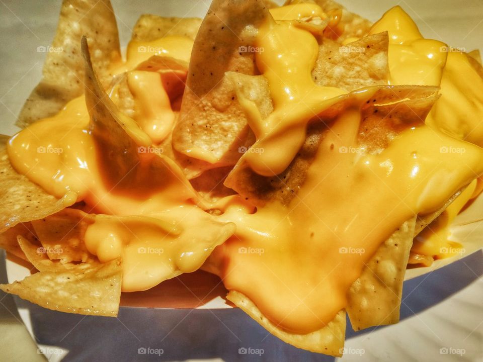 American Nachos Smothered In Cheese. Tortilla Chips Covered With Melted Cheese
