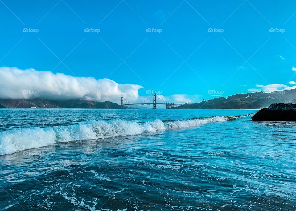 This photo was taken from China Beach, San Francisco and showcases the Golden Gate Bridge in the background. It was a beautiful morning with low fog and and wonderful blue hues.