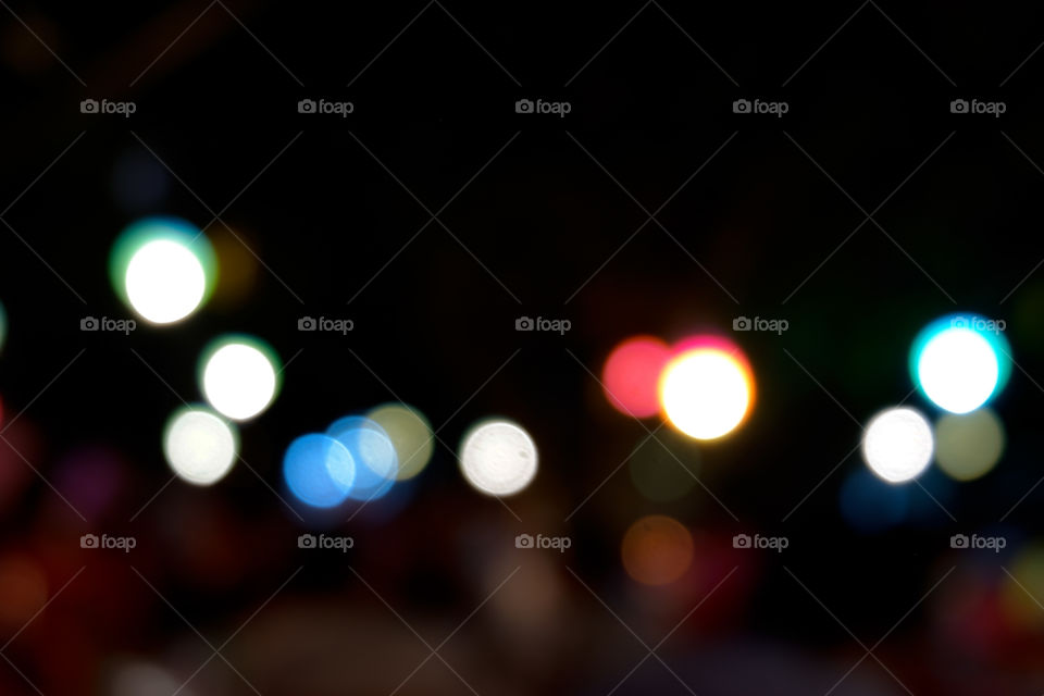 Blurred light bokeh in market fare at night. Concept of abstract and background texture.