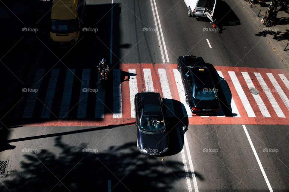 Light and shadow on a moving vehicle on the street. View from above,  Tbilisi, Georgia