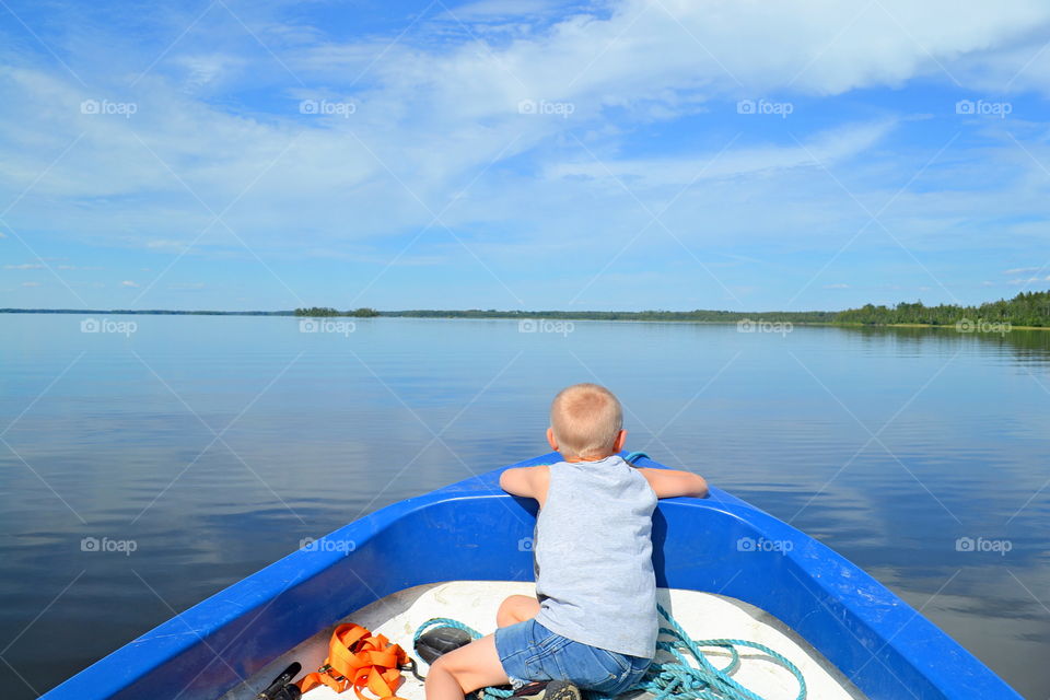 Boy sitting in a boat