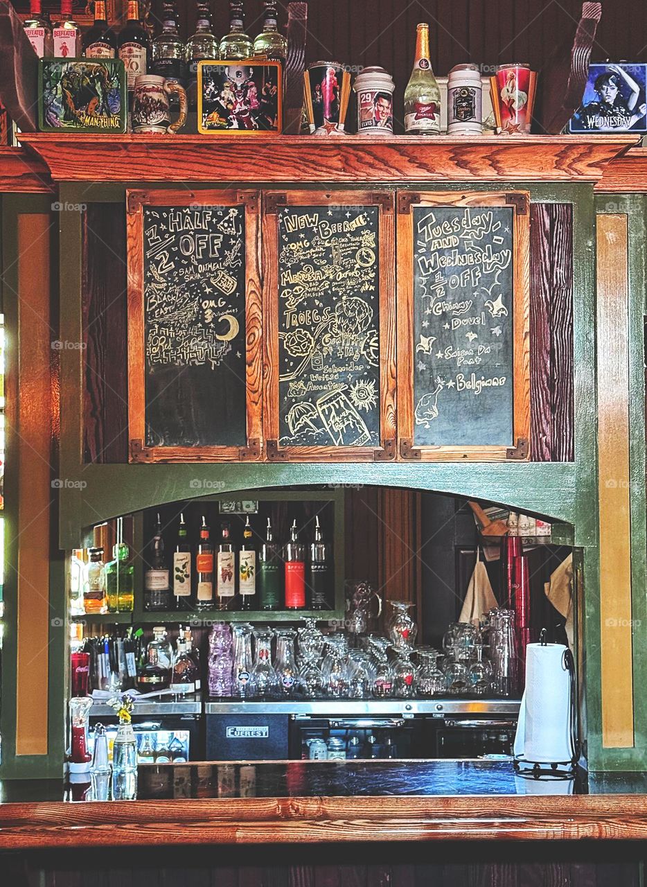 Cocktail menu on a chalkboard at a bar  