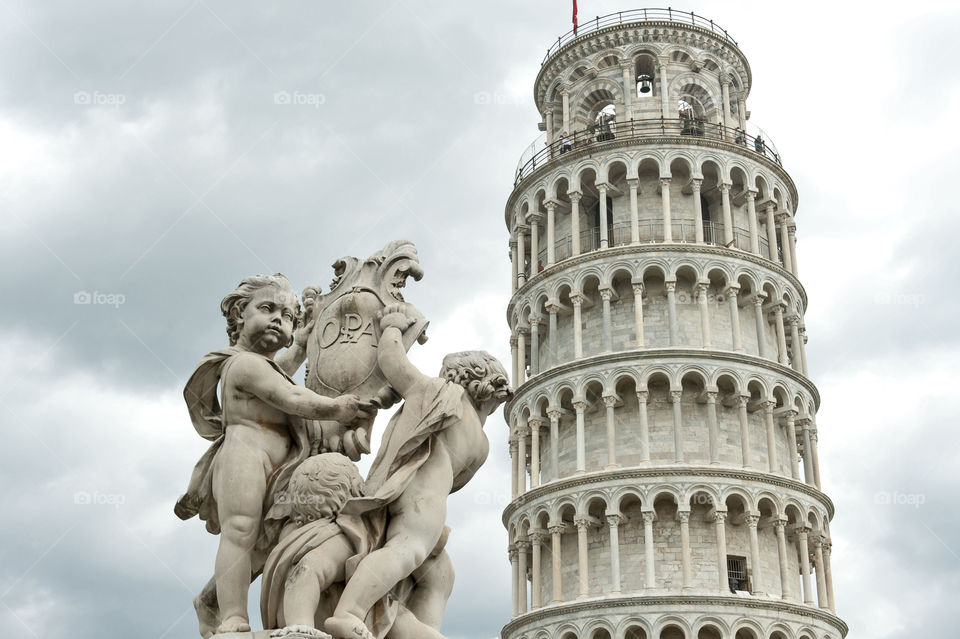 Angels state and leaning tower of Pisa, Italy 