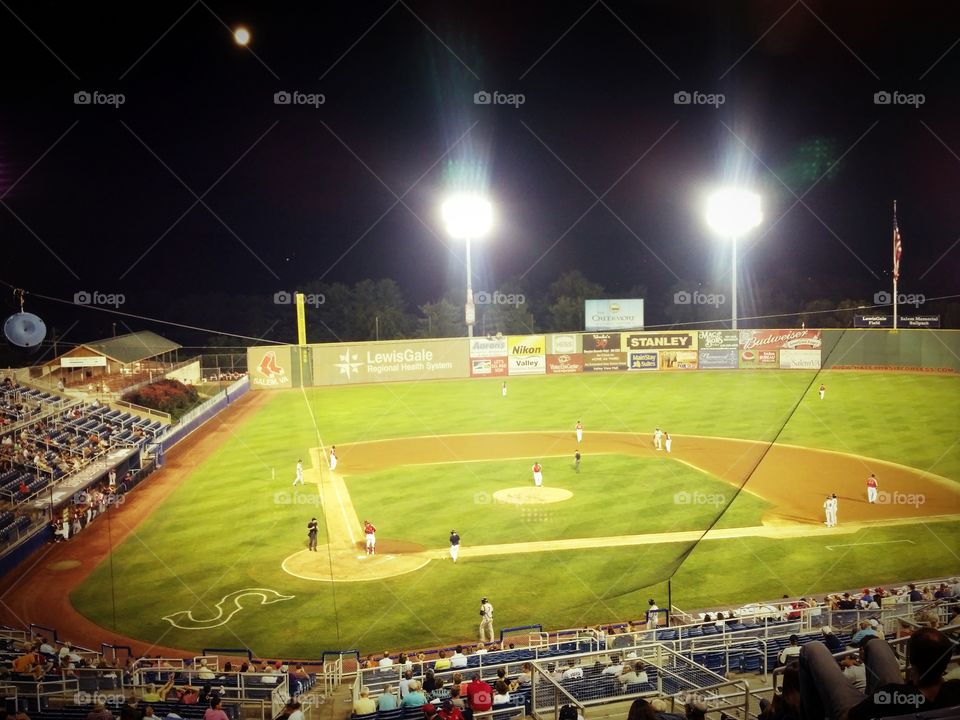 Nighttime baseball game on the diamond