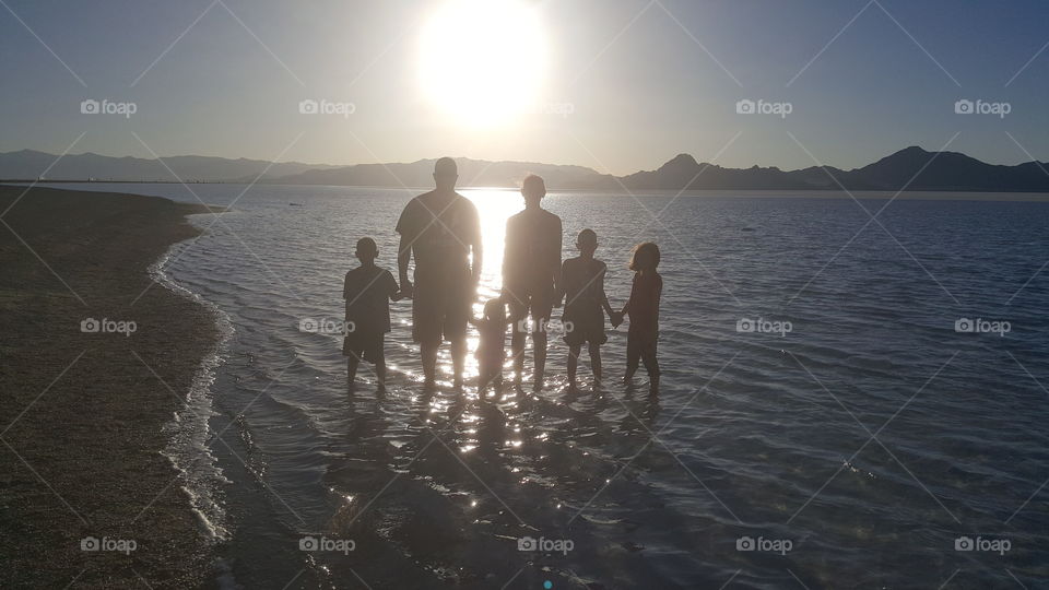 our family together near the Great Salt Lake near Salt Lake City Utah in 2017 silhouetted with the mountains in the background