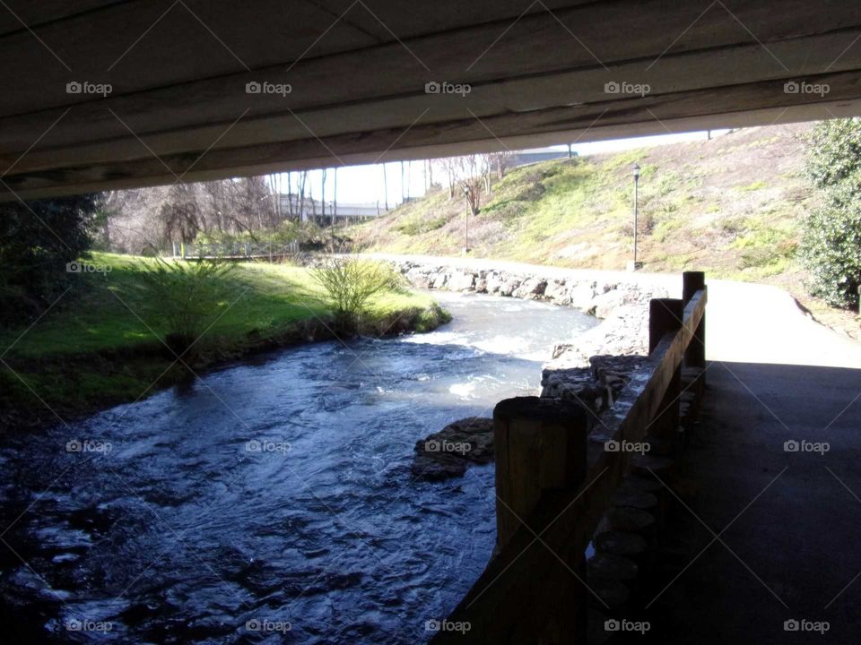 Beautiful stream running beneath a bridge