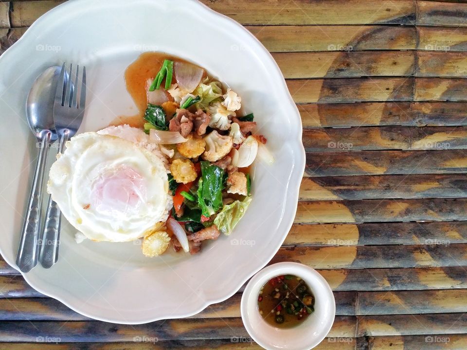 Vegetable fried rice with fried egg and fried pork