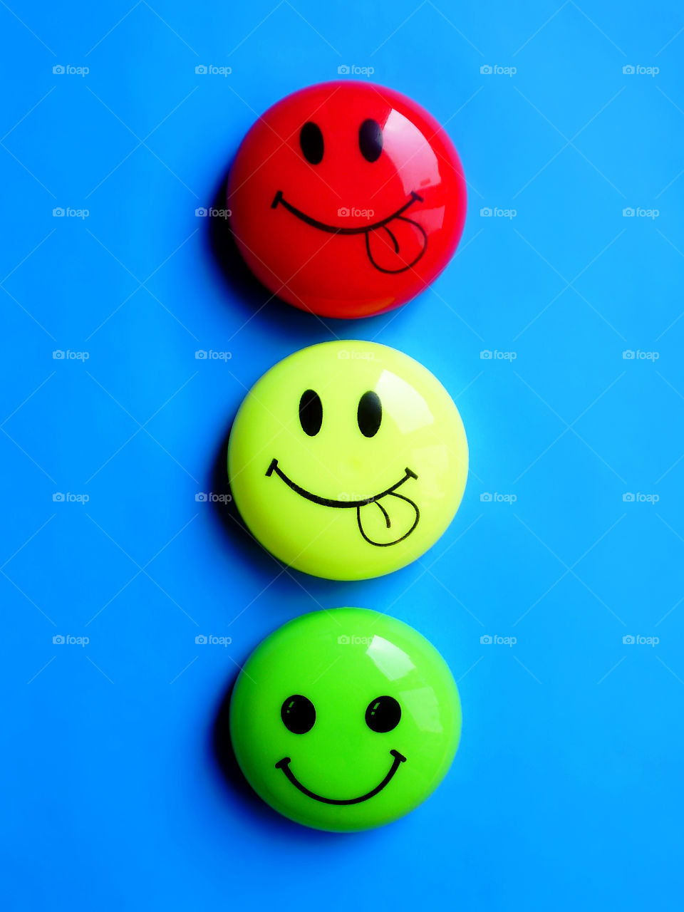 Three colorful smiles on blue background 