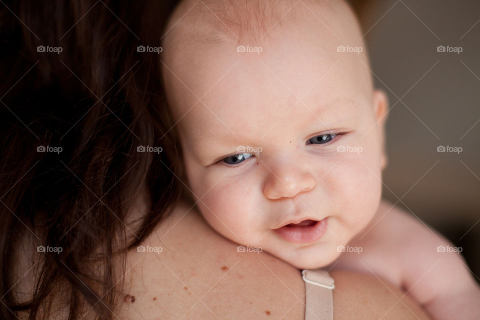 Baby boy and mothers shoulder