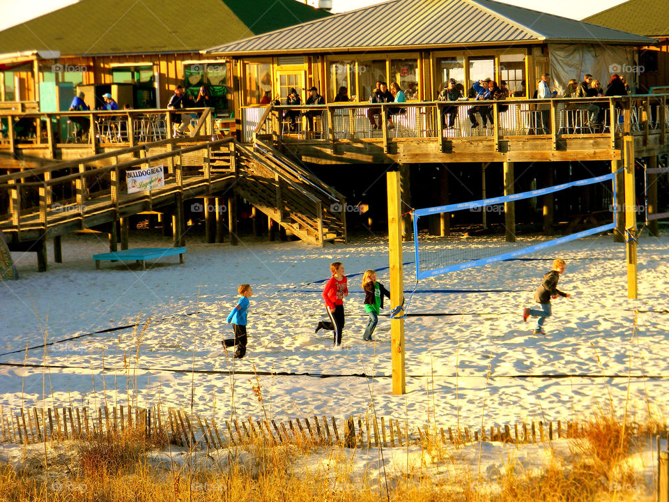 At the restaurant. People enjoying spring at a beach side restaurant 