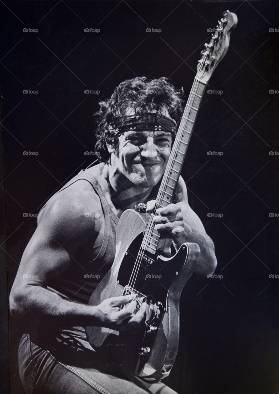bruce springsteen performs on stage. a young bruce springsteen by arizphotog