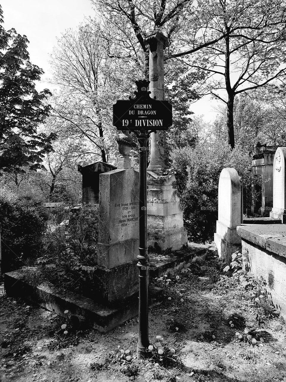 Black and white shot of a vintage sign post in Père Lachaise cemetary of Paris