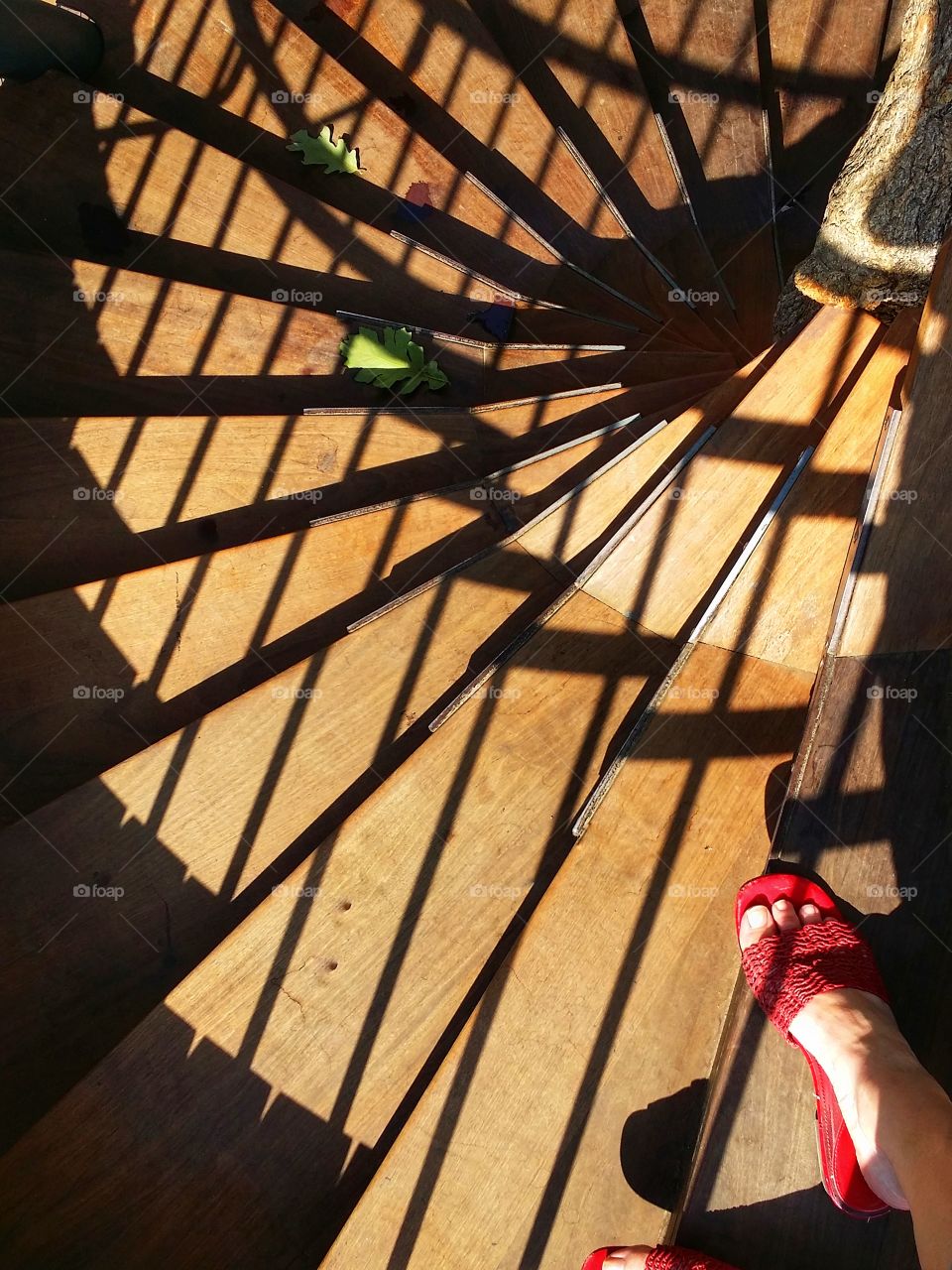 A woman walking down a spiral staircase