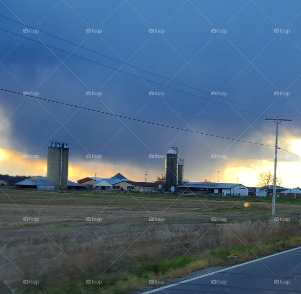 Fire in the Sky. sun setting behind a rain cloud.