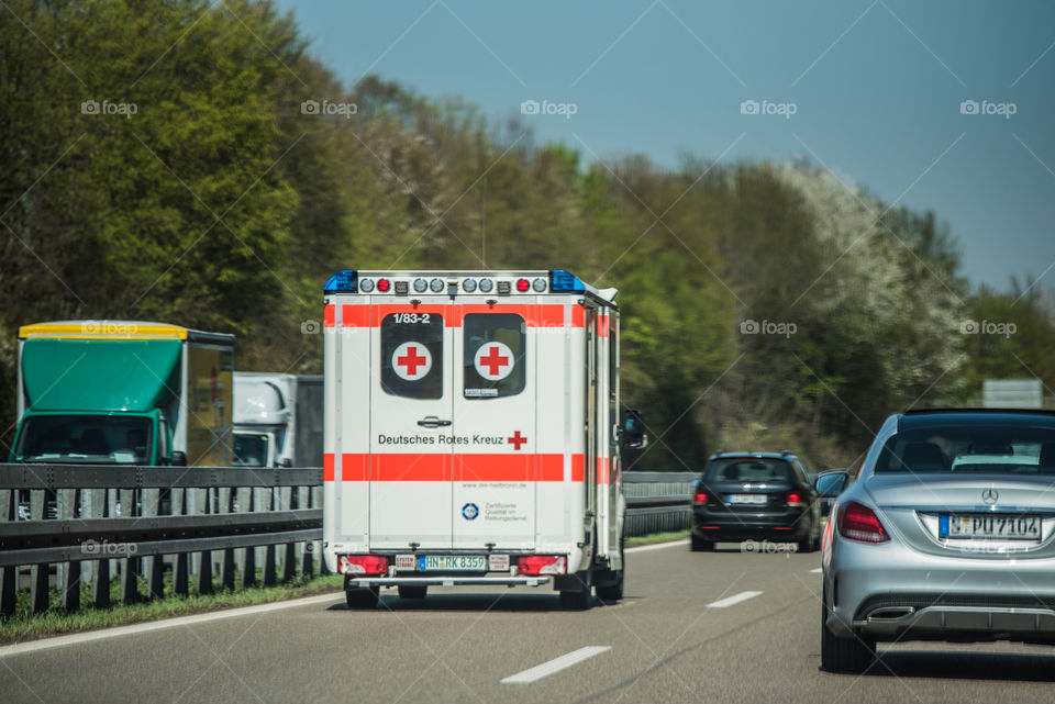 an ambulance traveling on a crowded highway in Germany