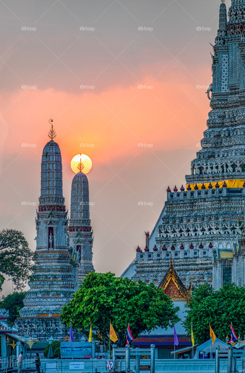 Beautiful scene of the sun on the top of pagoda at Wat Arun Thailand