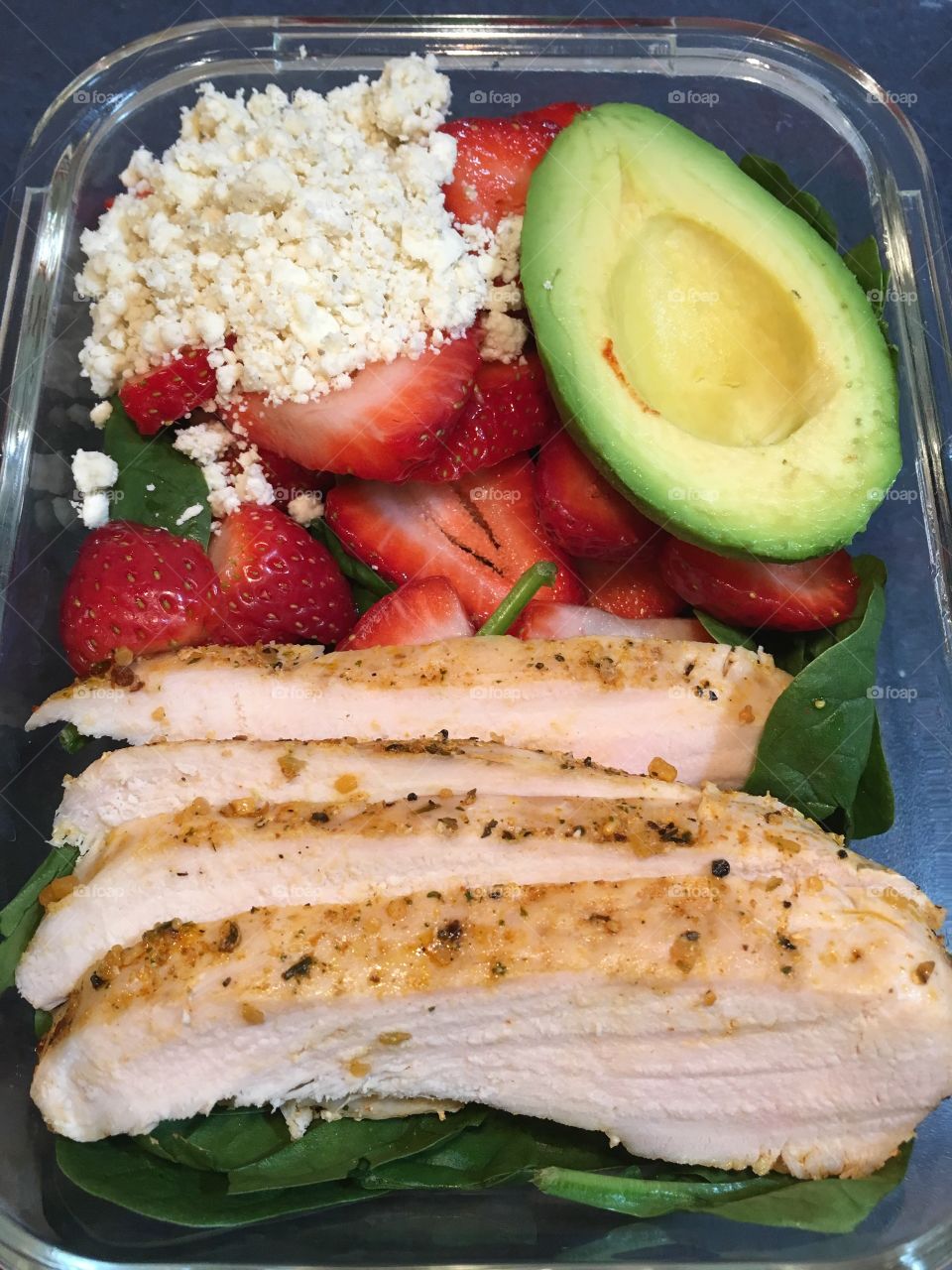 Strawberries, feta, grilled chicken and avocado spinach salad.