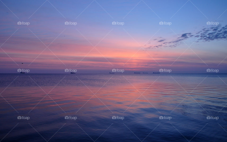 Sunrise over calm sea