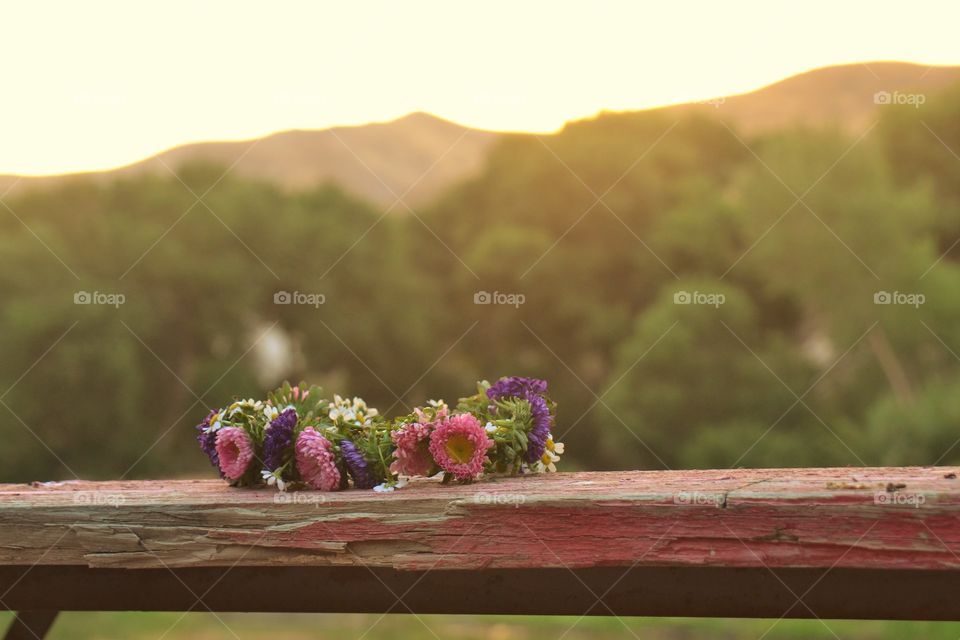 Flower crown on an old pink wooden table 