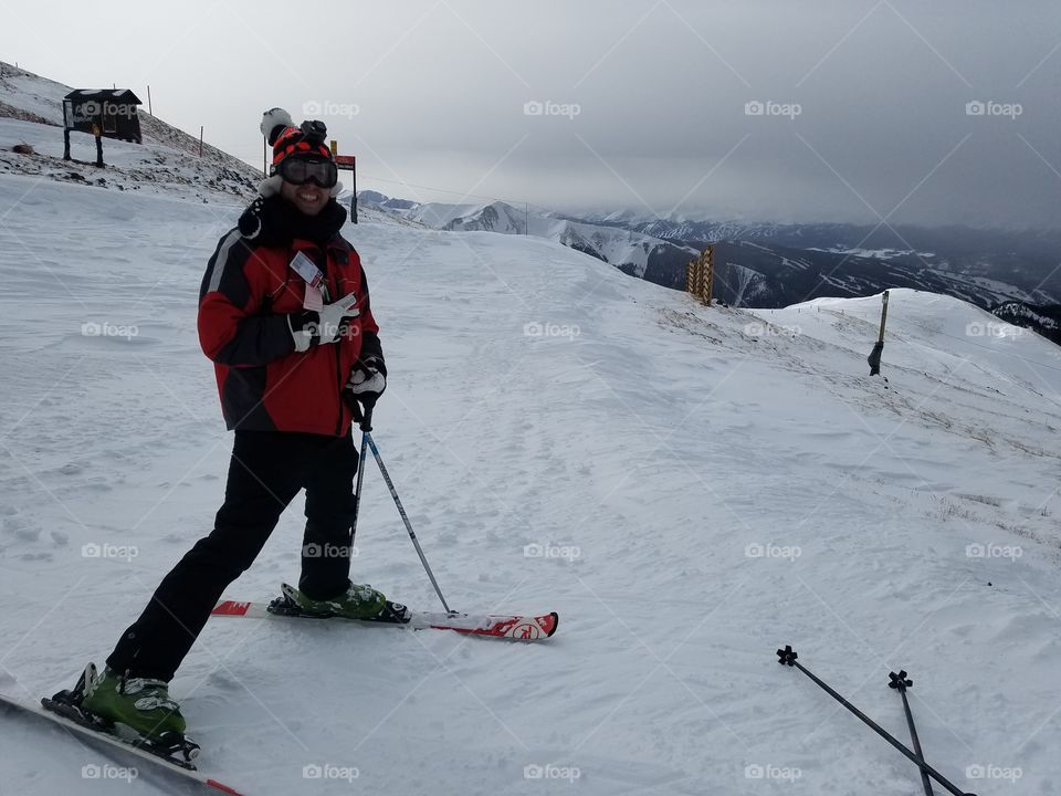 Me about to ski down the ridge of a mountain.