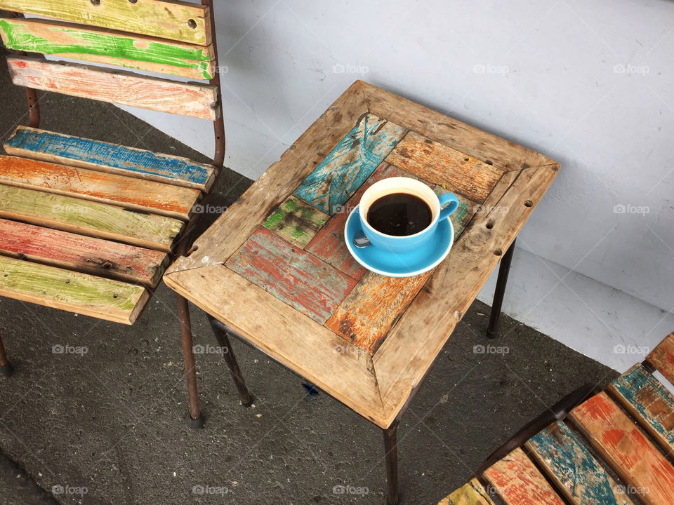 Cup of black coffee on a weathered wooden table