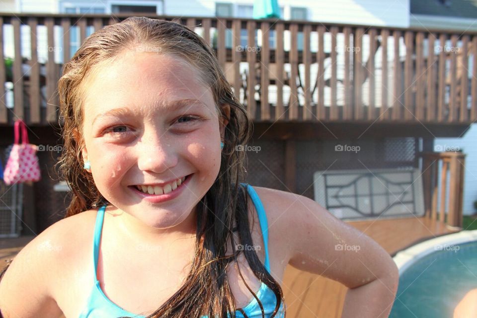 Smiling wet girl enjoying in resort