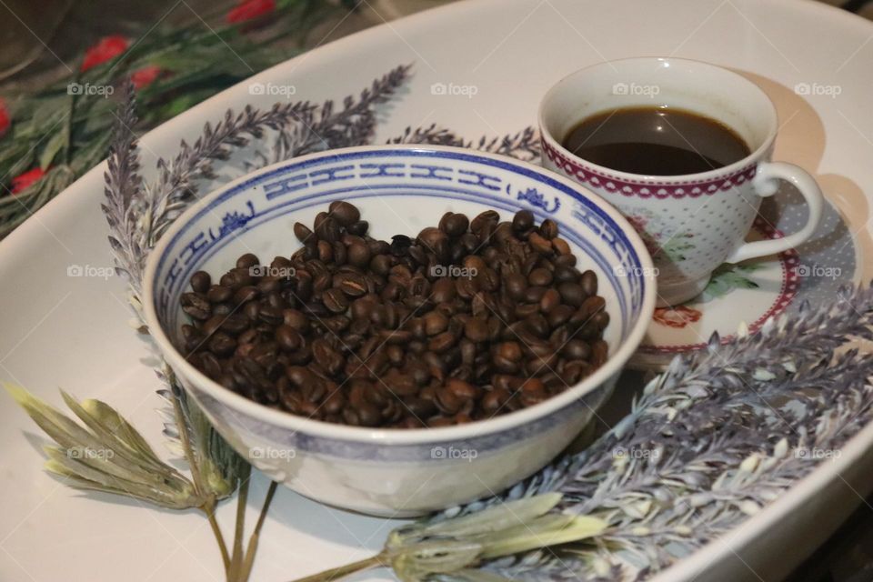 A cup of coffee and coffee beans