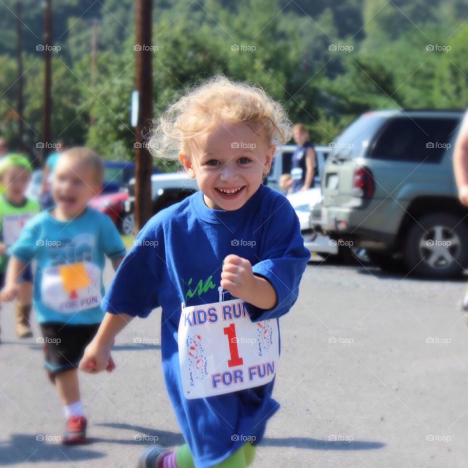 Happy Little Runner. Four year old child is all smiles while she's running!