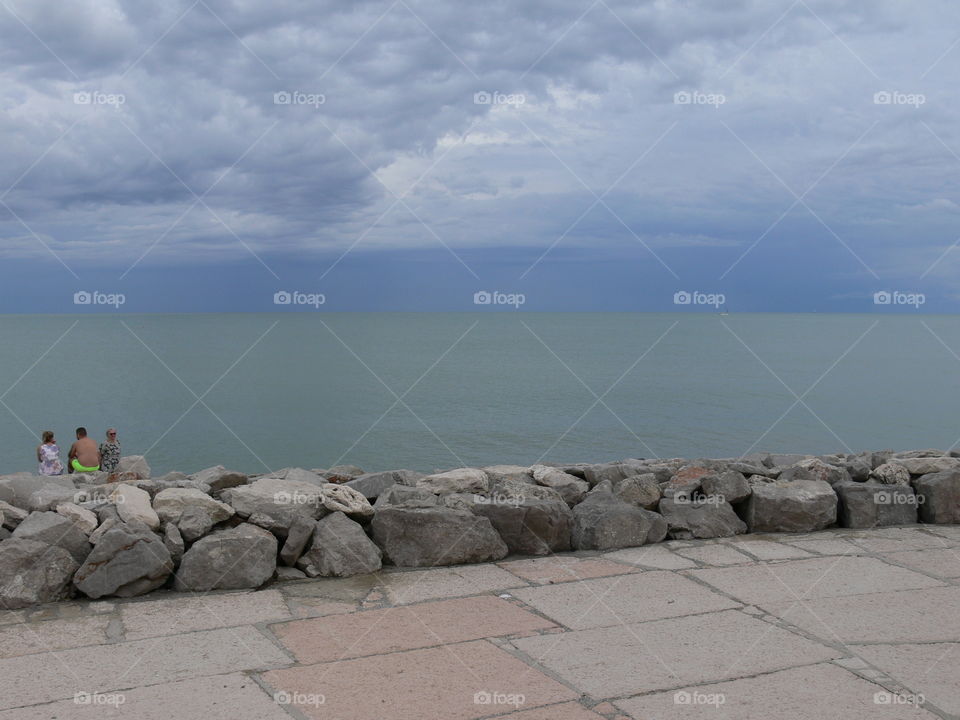 a sea horizon view from caorle venice italy city seafront rock promenade