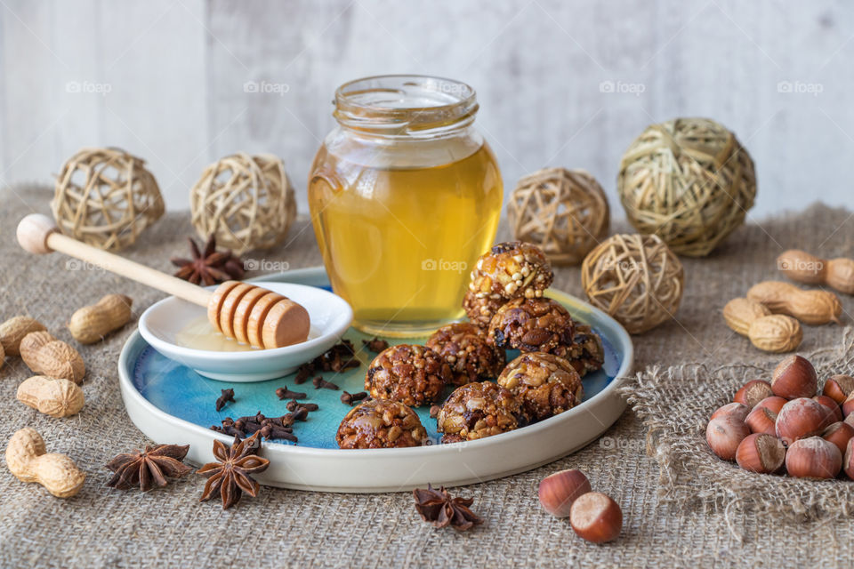 Still life made by handmade energy candy with nuts, quinoa, dry fruits and honey.