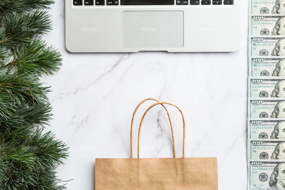 Holiday shopping. Flatlay items. Laptop, bag, Christmas tree 