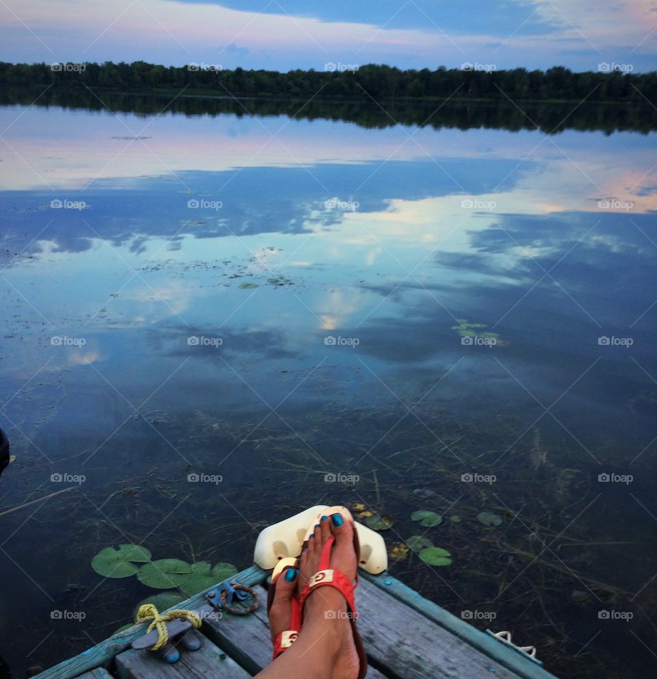 Relaxing on the dock admiring the sky's refection on the water
