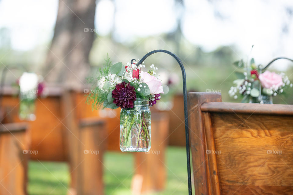Red and Pink Roses in a Mason Jar Hanging in wedding Isle