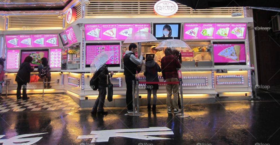 Harajuku, Tokyo, Japan. Takeshita Street.  Young People Wait in the Rain to Buy Crepes.
