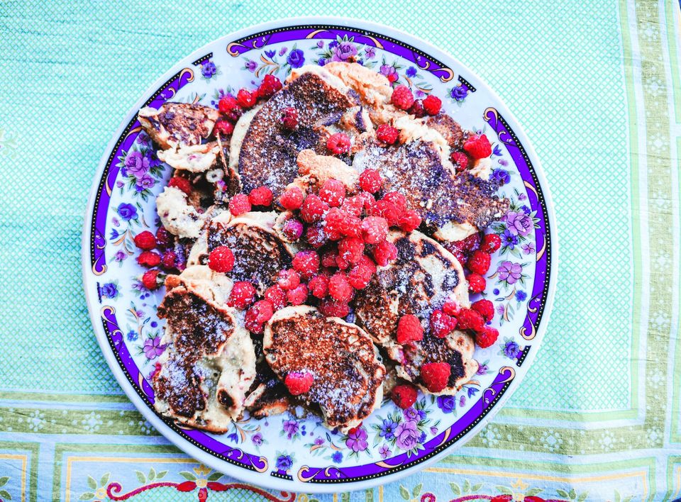 Pancakes with raspberry and sugar on a plate