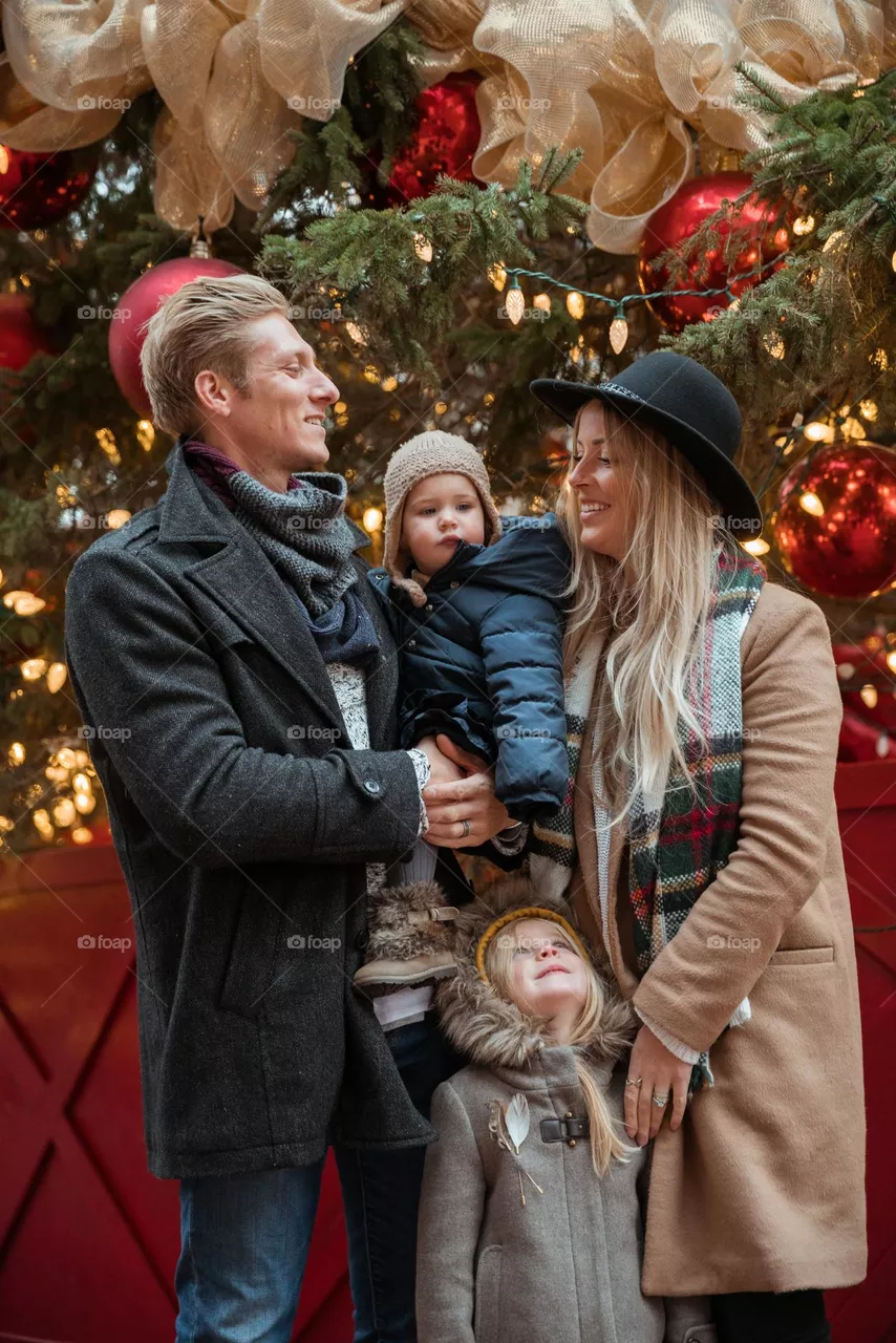 Family In Front Of Christmas Tree