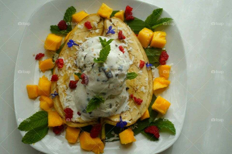 Ice cream on banana split with mint leaf