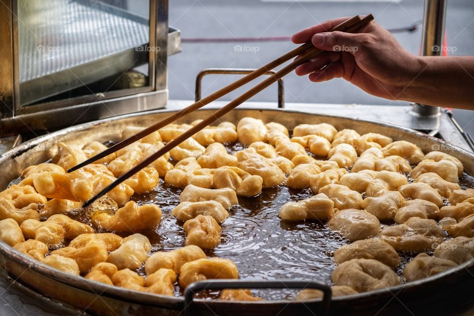 Deep-fried doughstick process at China town Bangkok Thailand