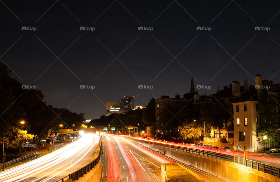 Cars speeding by late night in Boston. This photo was taken above Storrow Drive.