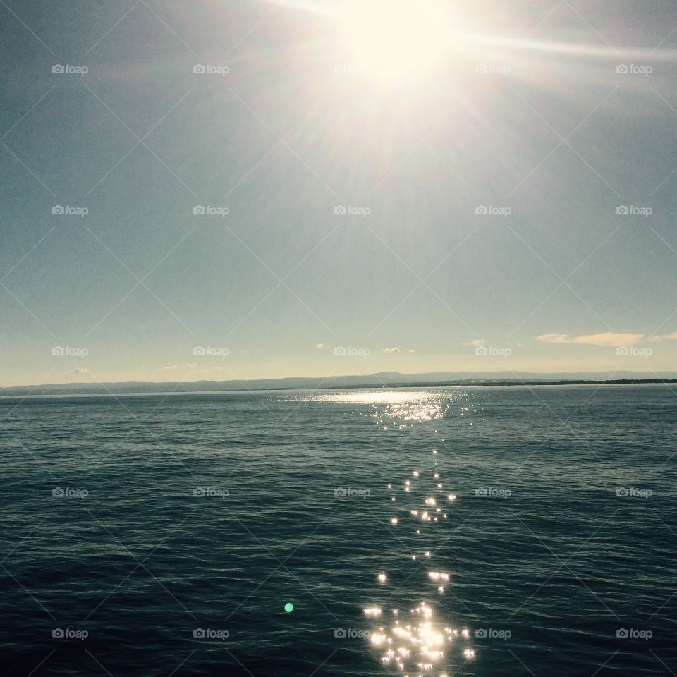 Sun rays hitting the sea in Sicily 