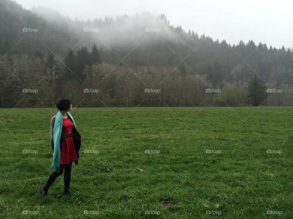 Girl looking at forest. Girl in field