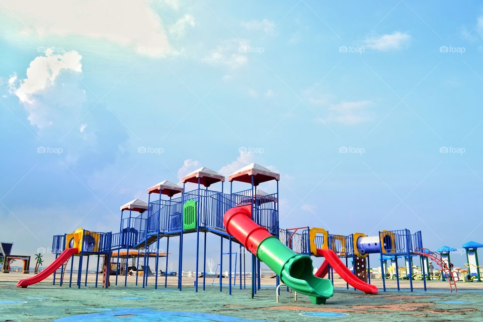 Colorful playground and blue sky background
