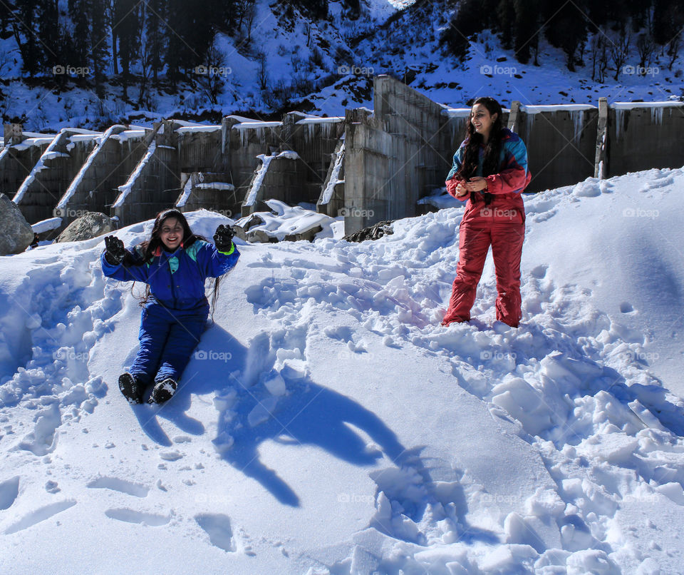 Ladies enjoying in the snow in their snow suits