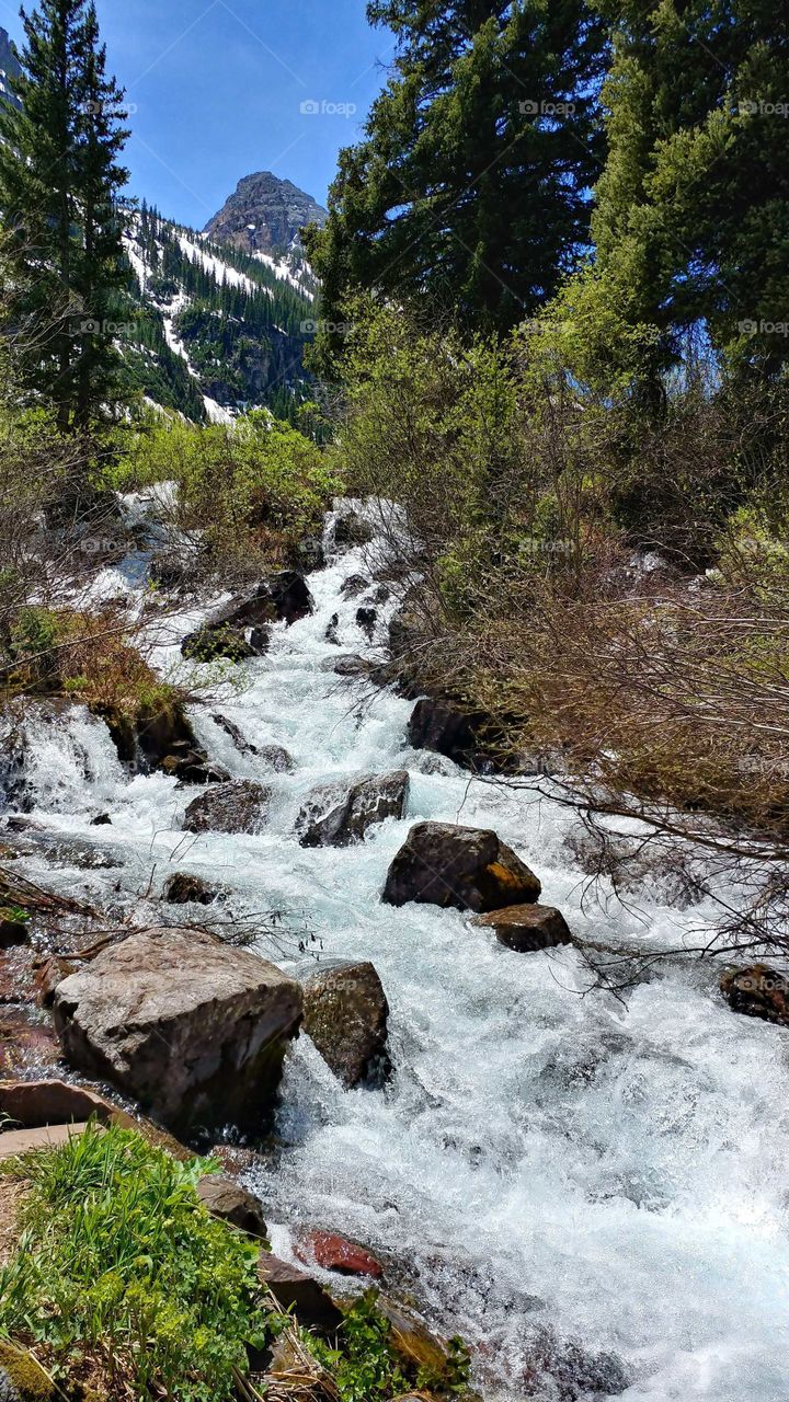 On a beautiful summer's day the waters of Maroon Creek cascade to the lake below.