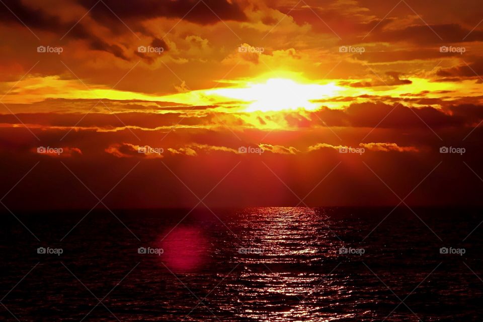 Gorgeous red and gold summer ocean sunset.