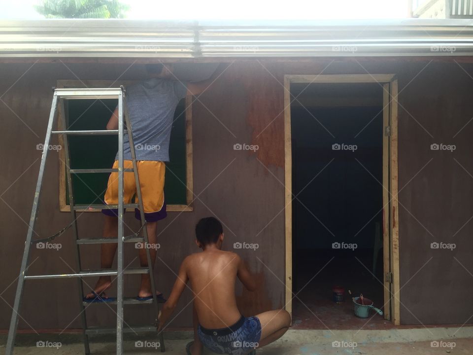 Teenagers painting their  little room