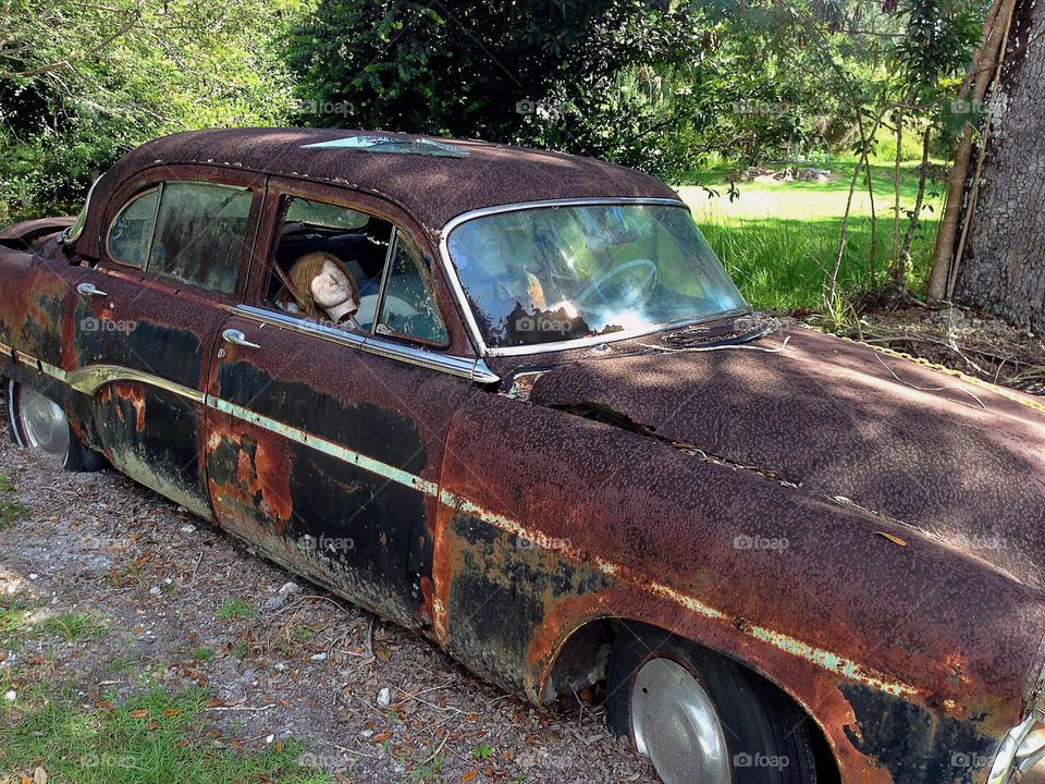 Antique car with mannequin.