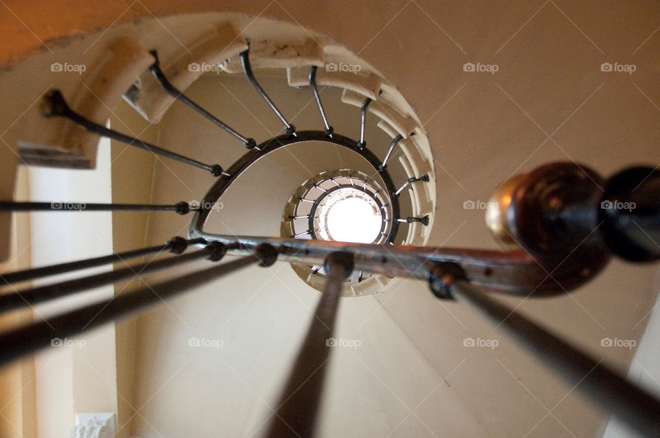 Looking up the center of a multistory spiral staircase