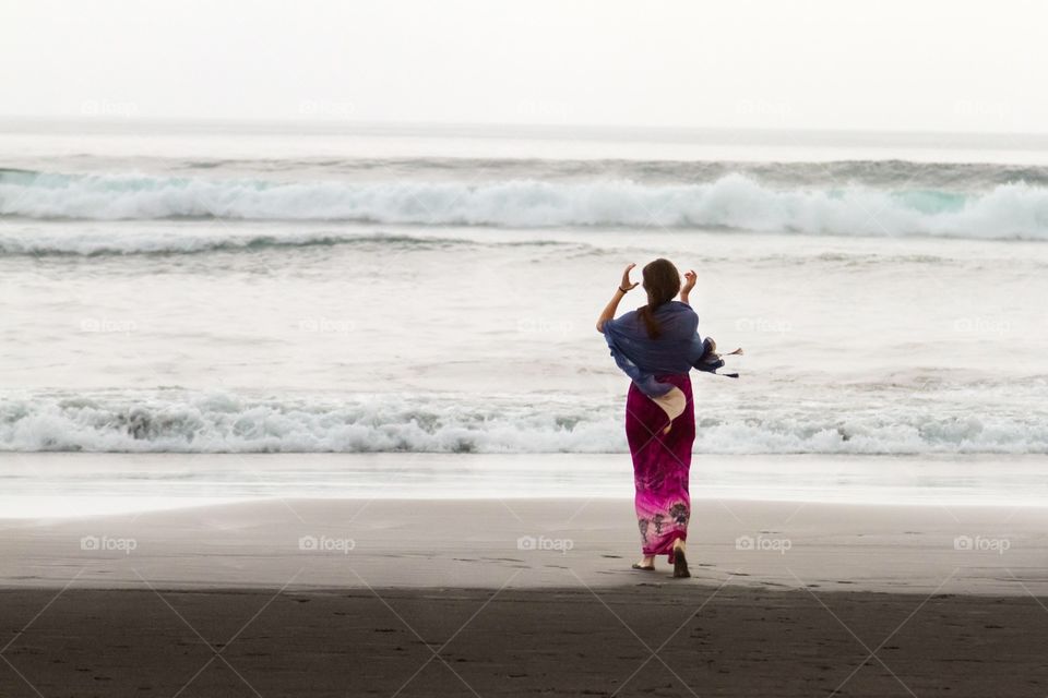 A woman goes to the ocean