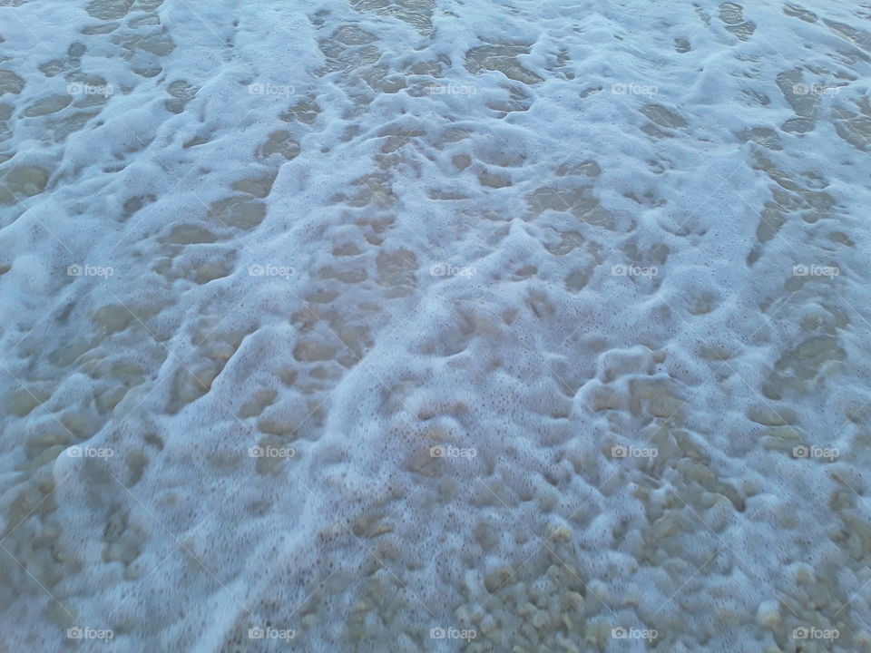 foam of outgoing waves into the atlantic ocean